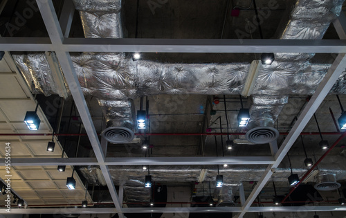 Ventilation system pipes on the ceiling of a modern factory plant building