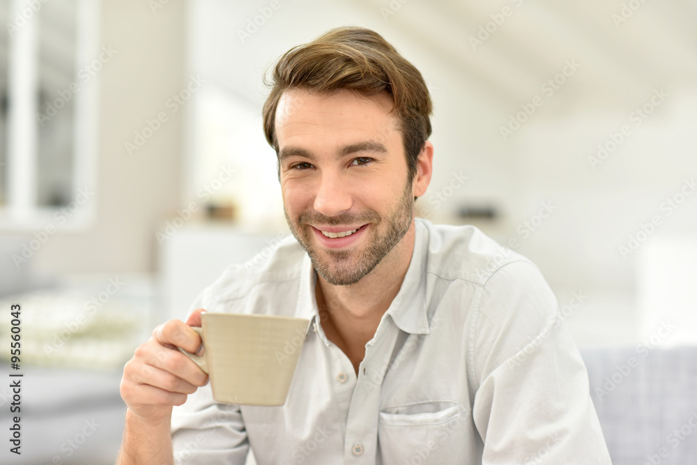 Portrait of handsome man at home, holding tea cup Portrait of handsome man at home, holding tea cup