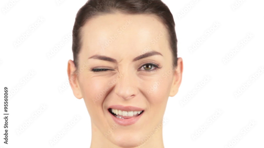 Young woman with an itch on her nose twitching, followed by a wink Young woman with an itch on her nose twitching, followed by a wink