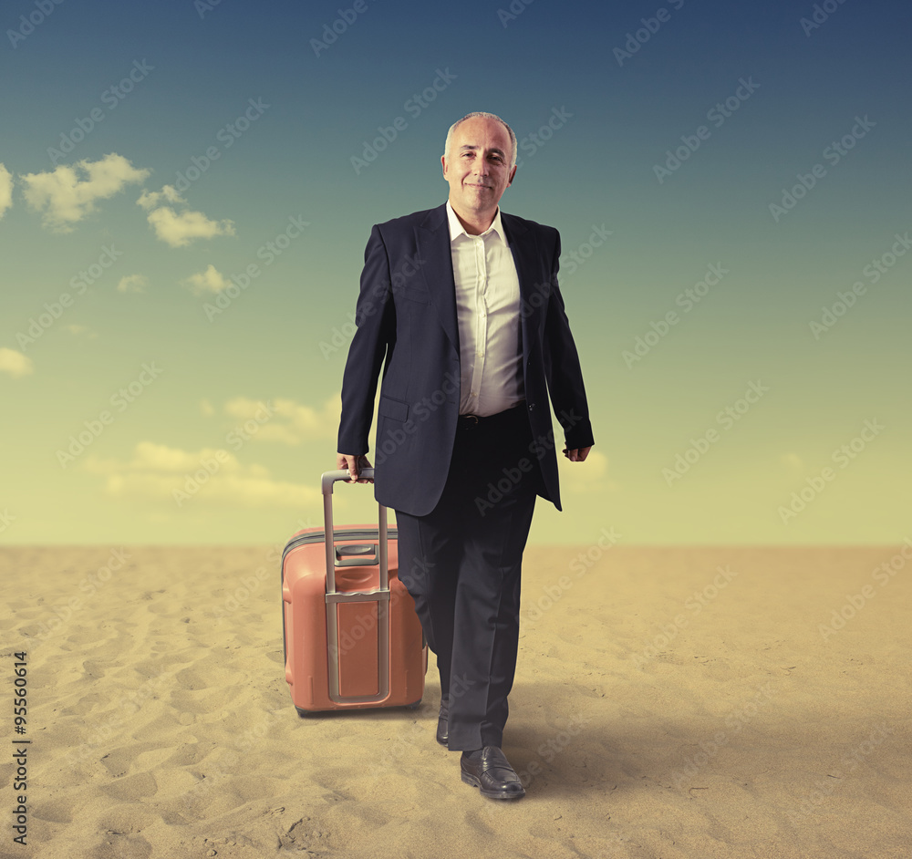walking senior man with suitcase in a desert walking senior man with suitcase in a desert