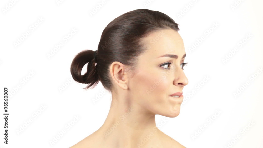 Attractive woman moving her eyes and head around in a confused or worried manner