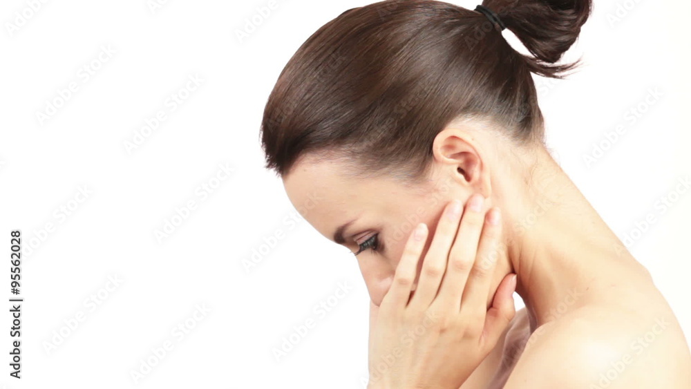 Attractive young woman smiling and holding her hands around her face and neck in a beauty style pose Attractive young woman smiling and holding her hands around her face and neck in a beauty style pose