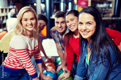 happy friends in bowling club