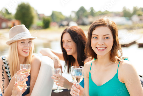 smiling girls with champagne glasses