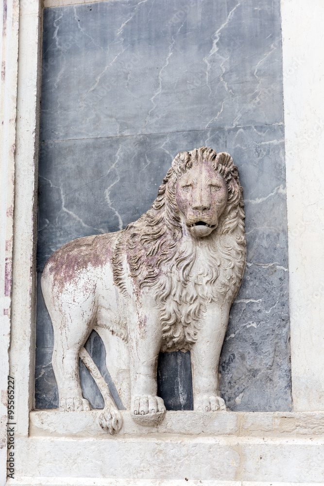 Marble bas-relief of a lion on ancient basilica church Santi Giovanni e Paolo in Venice, Italy