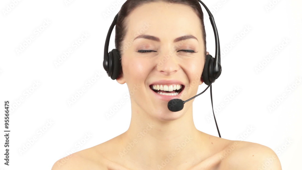 Attractive young woman wearing a telephone headset showing surprise and laughing Attractive young woman wearing a telephone headset showing surprise and laughing