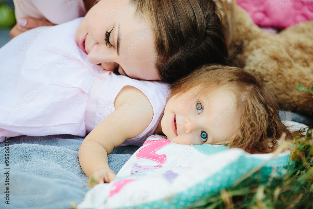 Young beautiful woman with her child outdoors Young beautiful woman with her child outdoors