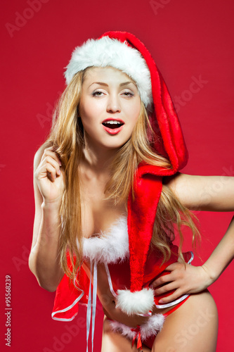 Sexy santa helper on red background