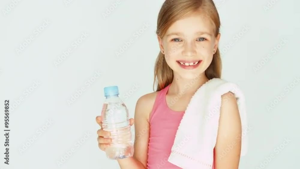 Portrait sportswoman girl child showing bottle of water. Thumb up. Ok. Zooming Portrait sportswoman girl child showing bottle of water. Thumb up. Ok. Zooming
