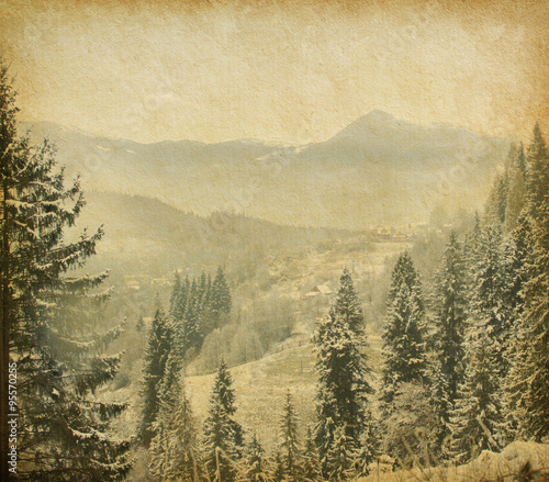 Retro image of winter landscape in the carpathians mountains. vintage paper .