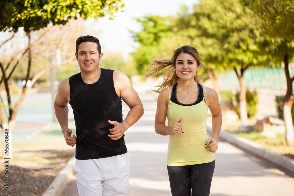 Cute Hispanic couple jogging together