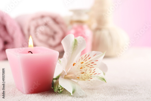 Spa treatment and flowers on wooden table, on light background