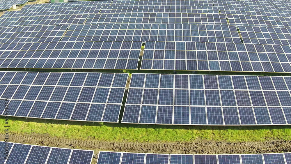 Flying over a modern Solar Farm looking across the panels Flying over a modern Solar Farm looking across the panels