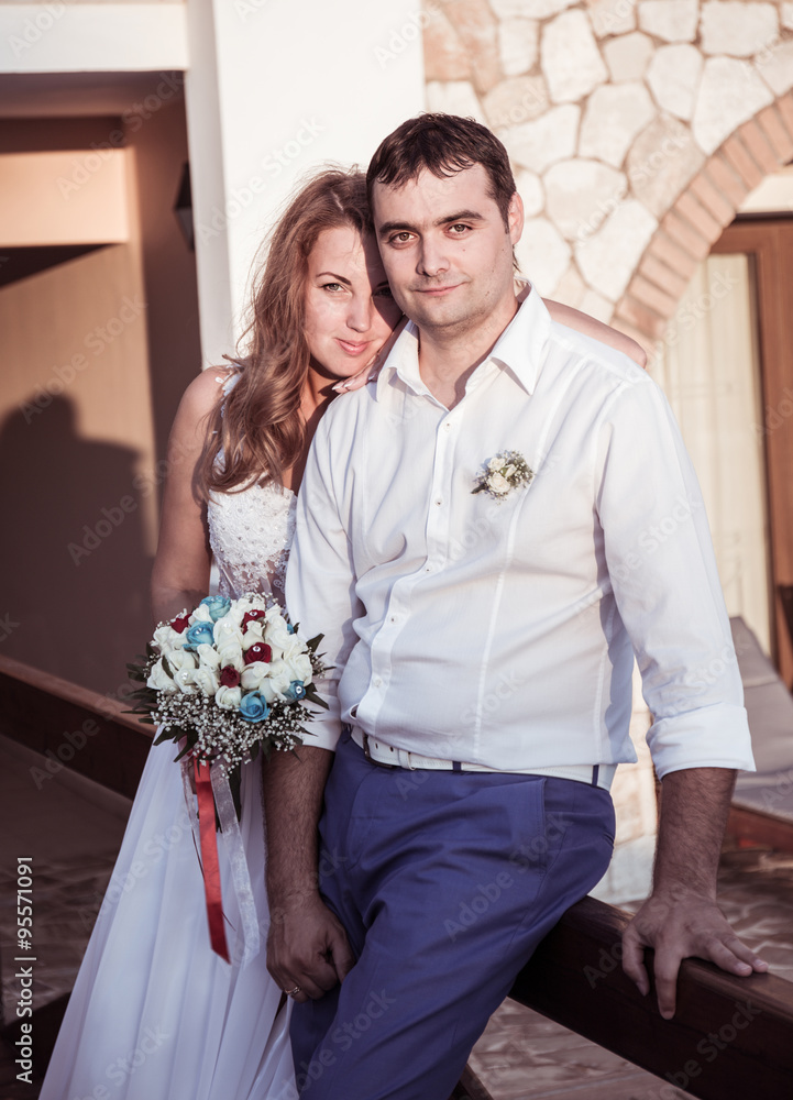 bride and groom posing on a bridge