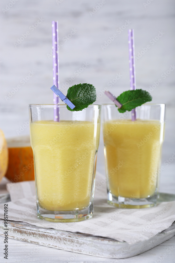 Glasses of melon cocktail on white wooden background Glasses of melon cocktail on white wooden background