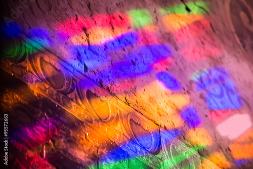 Reflections of a colored staines glass window in a church