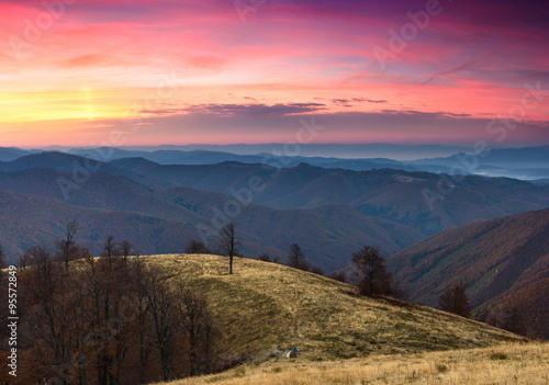 Landscape in the autumn mountains. Colorful clouds in the sunset.