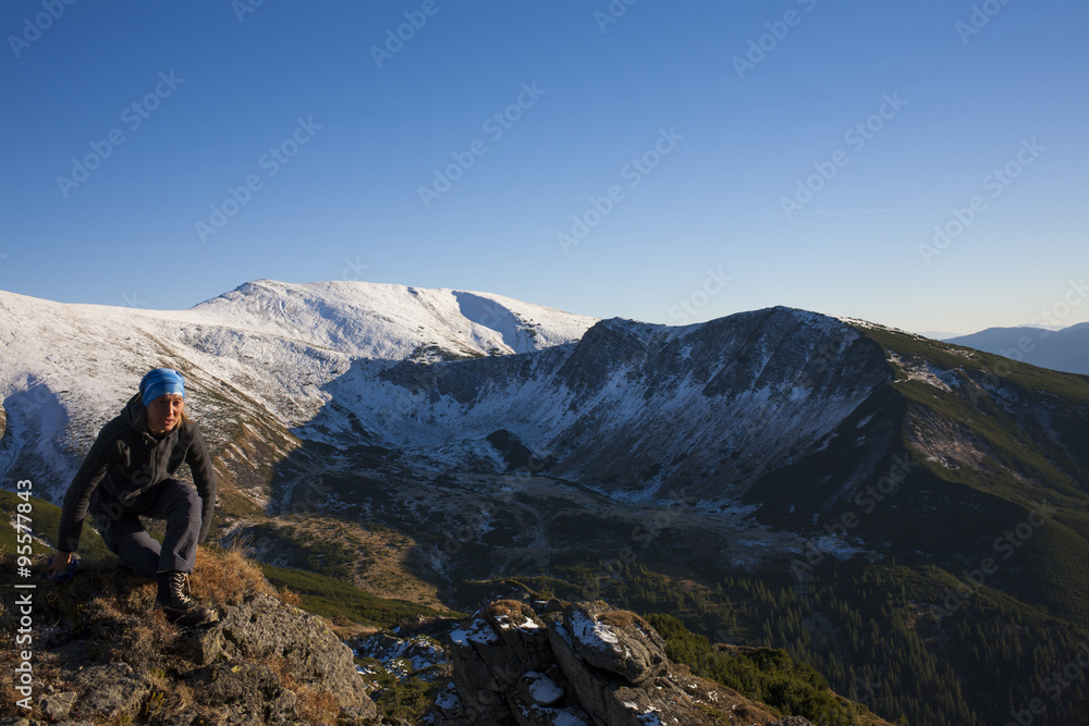 Fototapeta premium Girl meditates in the mountains.