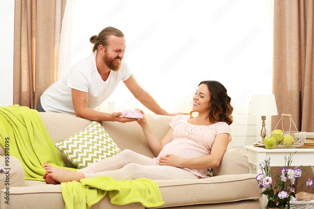 Handsome man and his lovely pregnant woman in the room Handsome man and his lovely pregnant woman in the room