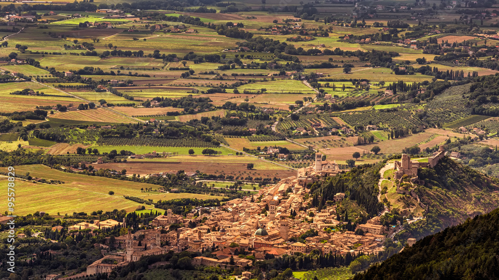 Panorama of the ancient town of Assisi in golden evening light, Umbria, Italy