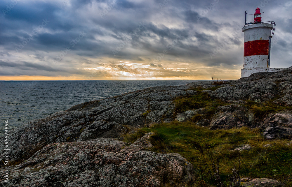 High ground lighthouse at the coast of Baltic Sea in Sweden in Sunset