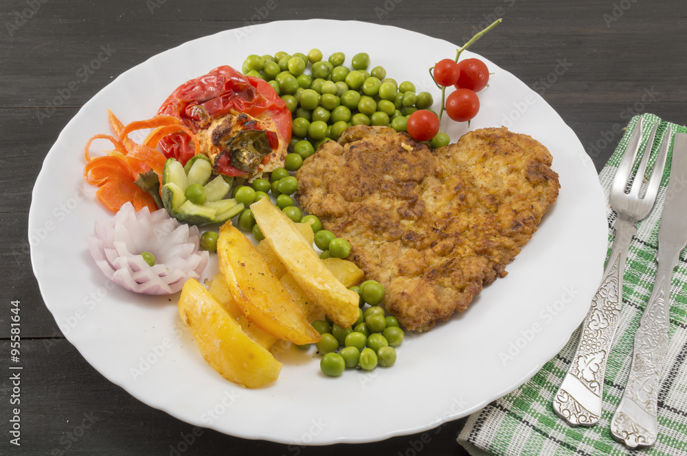 Steak with potatoes, cherry tomatoes and peas on plate Steak with potatoes, cherry tomatoes and peas on plate