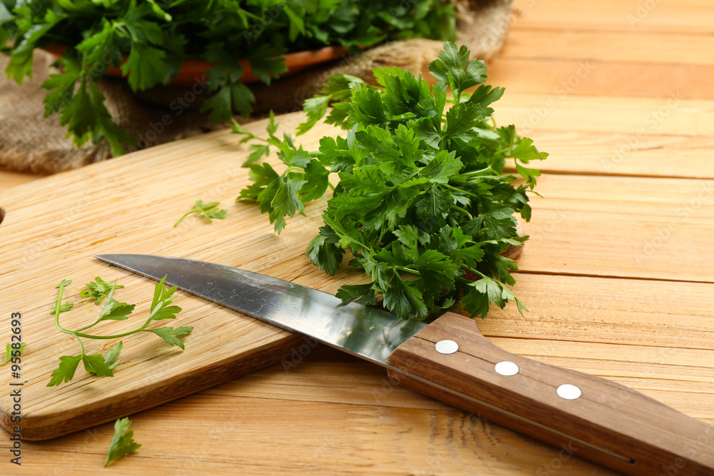 Fresh parsley on wooden cutting board Fresh parsley on wooden cutting board