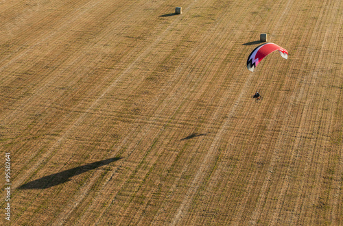 aerial view of paramotor flying over the fields