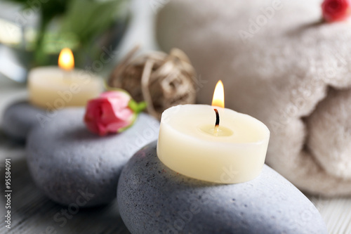 Composition of flowers  candles and stones  in spa salon  close-up