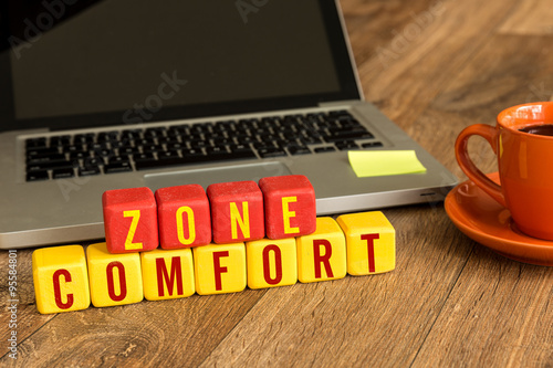 Fotografi Comfort Zone written on a wooden cube in office desk