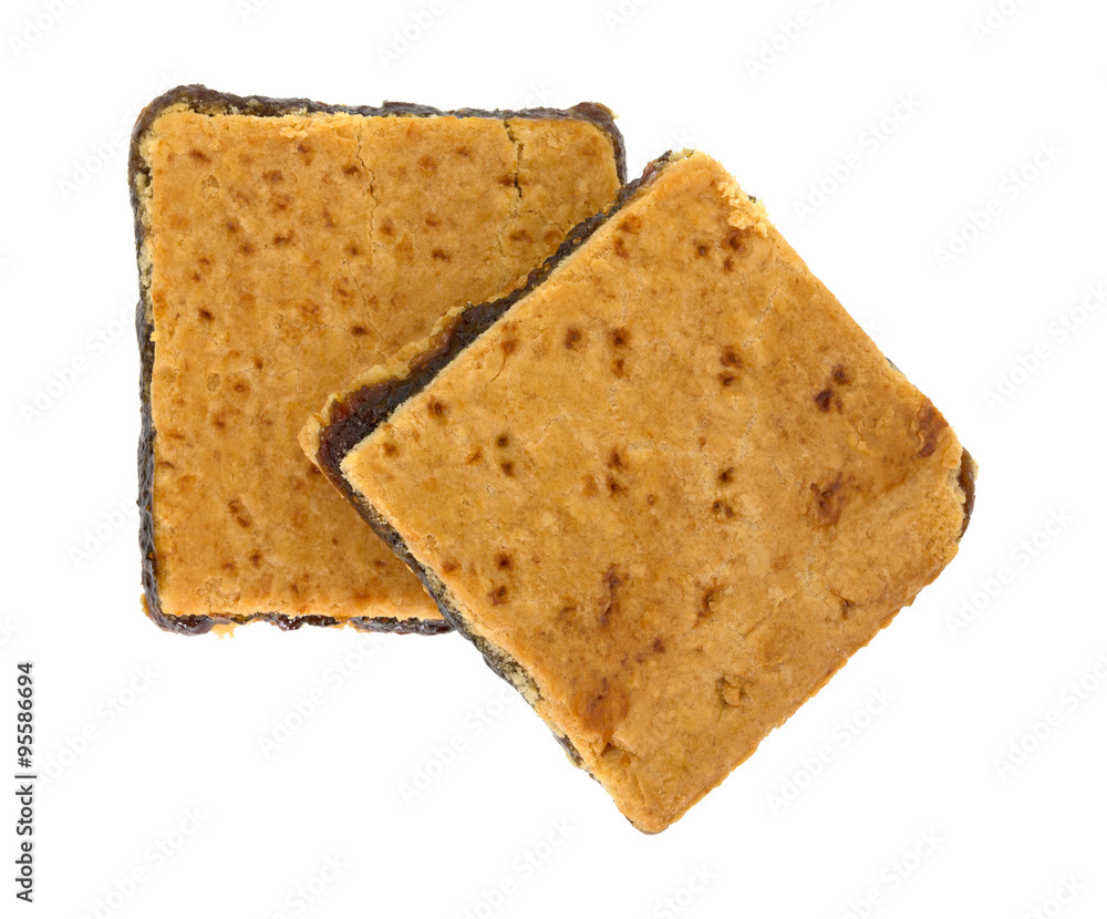Fototapeta premium Two homemade fig bar squares on a white background