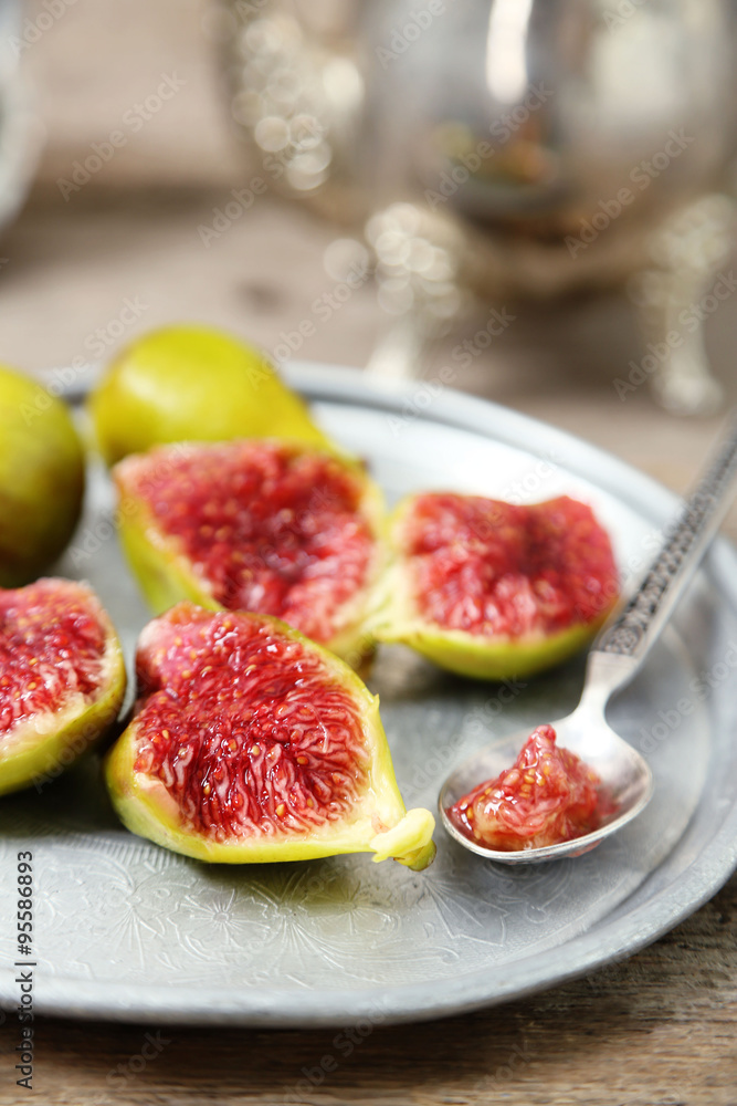 Ripe figs on tray, on wooden background Ripe figs on tray, on wooden background