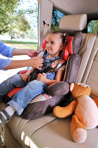 Cute little girl sitting in...