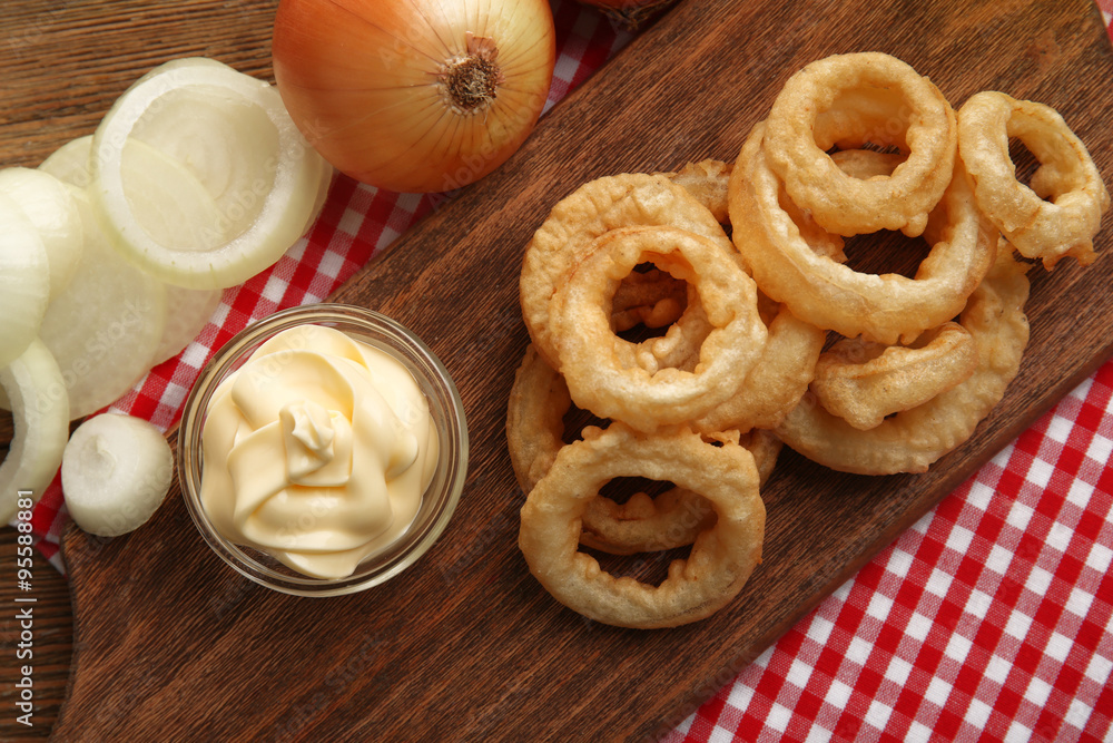 Chips rings with sauce and onion on cutting board closeup Chips rings with sauce and onion on cutting board closeup