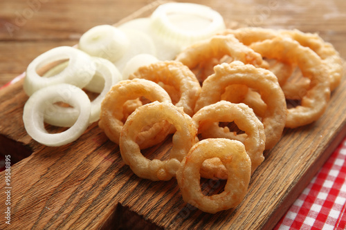 Chips rings with onion on cutting board closeup © Africa Studio