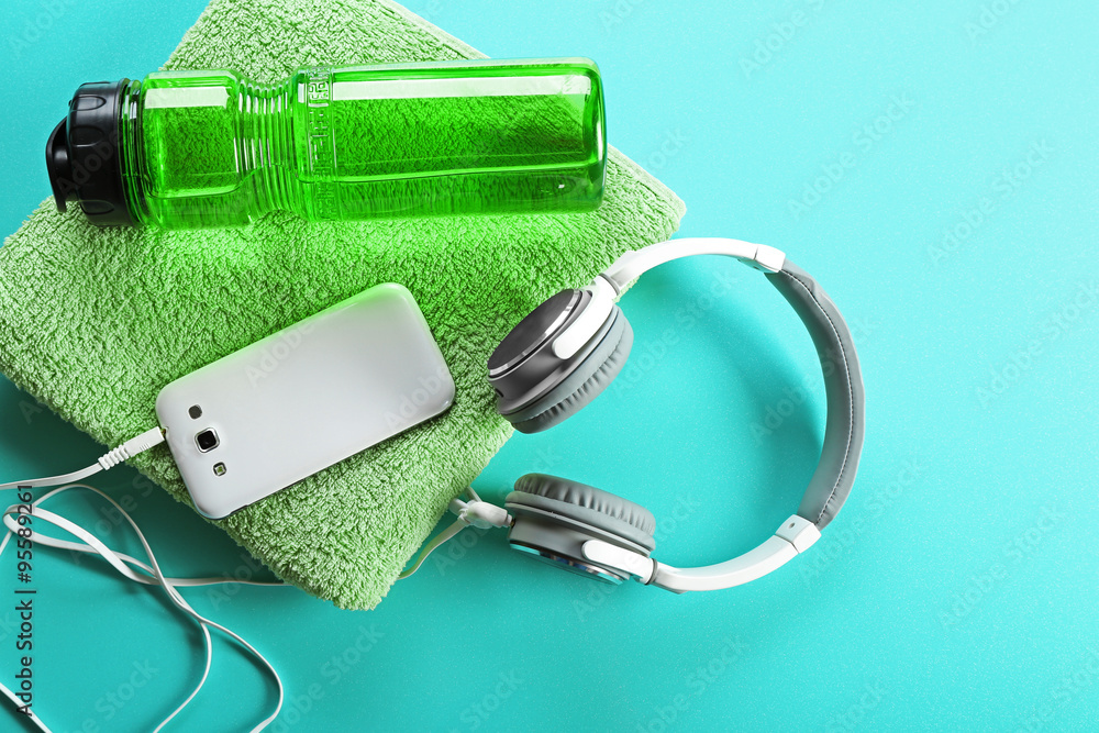 Headphones and sport equipment on blue background Headphones and sport equipment on blue background