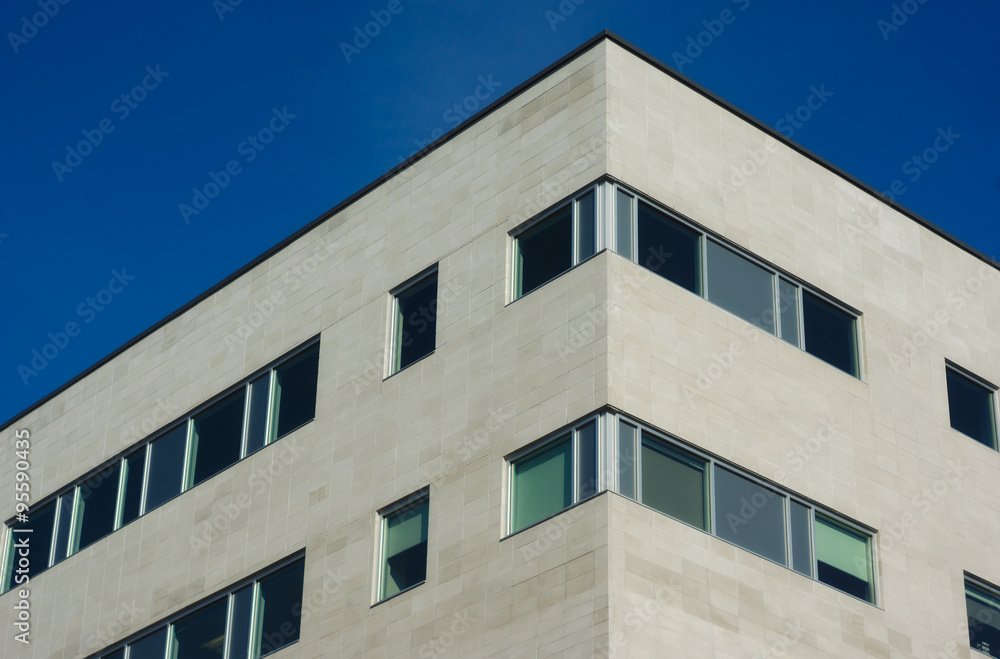 apartment building wall detail and windows on blue sky