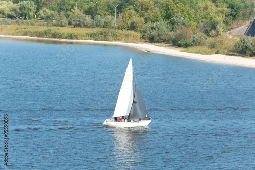 Sailing yacht on river