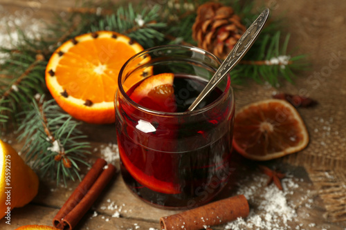 Mulled wine in glass bank on decorated wooden table