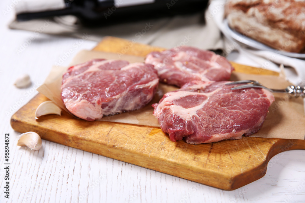 Marbled beef steak with bottle of wine and spices on wooden background