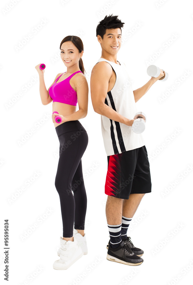 Young happy couple exercising with dumbbell Young happy couple exercising with dumbbell
