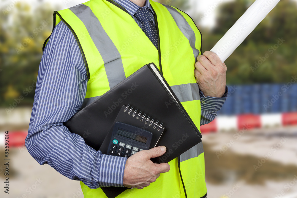 Building surveyor in hi vis carrying work folders and calculator Stock  Photo | Adobe Stock