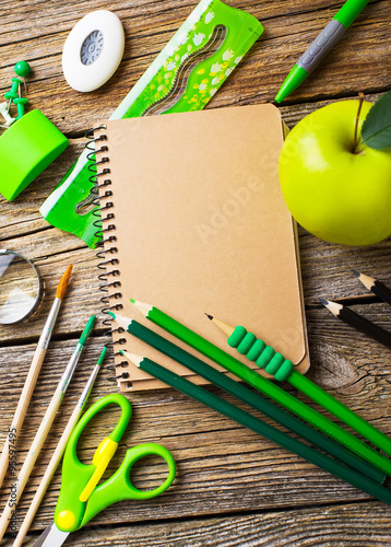 School supplies of green on a wooden background