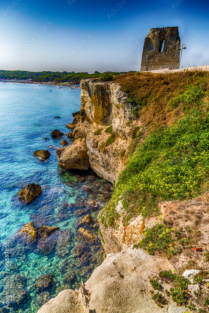 Ruins of watchtower on cove on the coast of Puglia