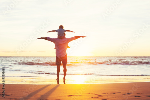 Father and Son Playing on the Beach at Sunset