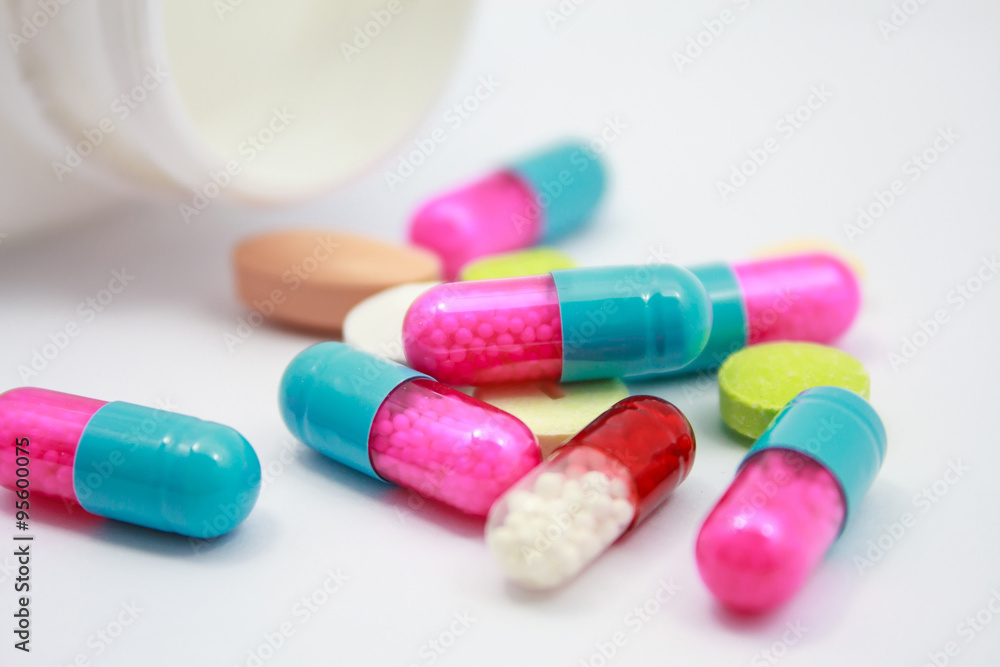 Colored pills, tablets and capsules on white background Colored pills, tablets and capsules on white background