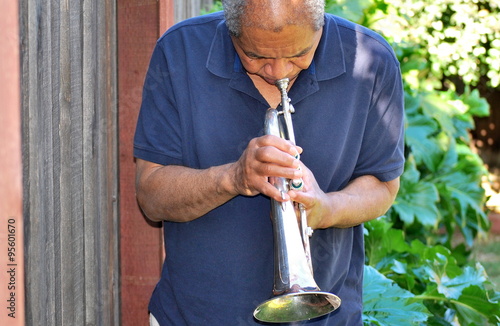 Wall Mural African american jazz musician with his flugelhorn outdoors.