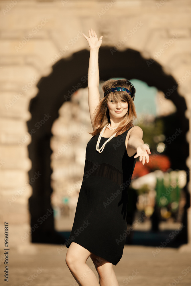 Fototapeta premium Flapper girl woman in1920s style standing on the street