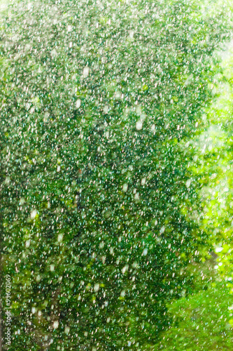 Rainy outside window green background texture.