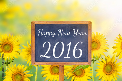 Fototapeta Naklejka Na Ścianę i Meble -  Happy new year 2016 on blackboard with sunflower background